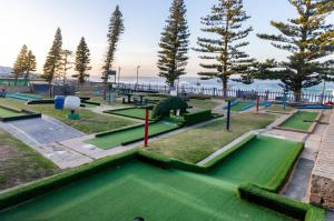 a park with a playground with green grass and trees at Harbour House Mossel Bay - near sea & activities in Mossel Bay