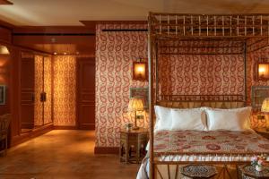 a bedroom with a canopy bed and a table at Albergo Hotel in Beirut