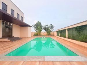 a swimming pool in the middle of a house at Moonstone Royal Resort in Jāmb