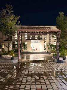 a building with a pavilion in front of it at Moonstone Royal Resort in Jāmb