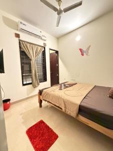 a bedroom with a bed and a window with a fan at Moonstone Royal Resort in Jāmb
