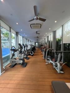 a gym with a row of treadmills and machines at Apartment klcc area in Kuala Lumpur
