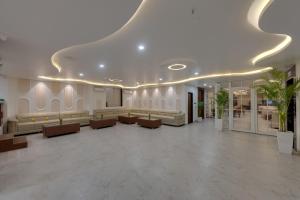 a lobby with a waiting room with couches and tables at Click Collection Ayodhya in Ayodhya