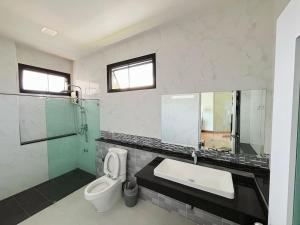a bathroom with a toilet and a sink and a shower at Live with lion in Chiang Mai