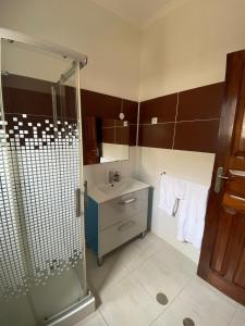 a bathroom with a shower and a sink at Residencial Aeroporto in São Tomé +48 photos
