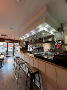 a bar in a restaurant with bar stools at Hotel NIU a 50 m del Funicamp in Encamp