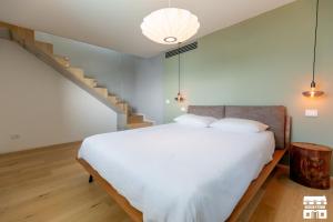a bedroom with a bed and a staircase at APPARTAMENTO BELAGO by Design Studio in Bellano