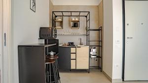 a small kitchen with a black and white appliances at TerrAmare Suites in Baronissi