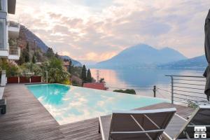 a swimming pool with a view of the water and mountains at APPARTAMENTO BELAGO by Design Studio in Bellano