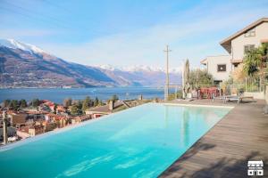 a swimming pool with a view of the water and mountains at APPARTAMENTO BELAGO by Design Studio in Bellano +17 photos