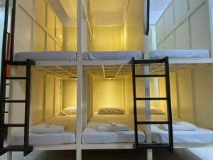 a room with three bunk beds in it at B2 Capsule Sleep Pods in Guiuan