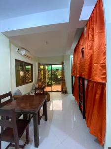 a living room with a wooden table and a dining room at B2 Capsule Sleep Pods in Guiuan