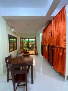 a dining room with a wooden table and chairs at B2 Capsule Sleep Pods in Guiuan