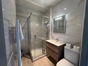 a bathroom with a shower and a toilet and a sink at Hôtel Windsor in Cannes +23 photos