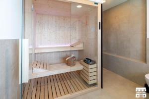 a walk in shower in a bathroom with a glass door at APPARTAMENTO BELAGO by Design Studio in Bellano