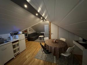 a kitchen and a dining room with a table in a room at Apartment Bjarmaland in Vestmannaeyjar