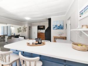 a kitchen and living room with a table and chairs at 32 Main Road in Struisbaai