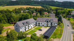 an aerial view of a large house with a road at Apartmán U mlýnu in Červená Voda
