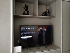 a flat screen tv sitting in a room at Sweet Escape 22 at O Residences in Bacolod