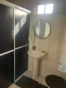 a bathroom with a sink and a mirror at Pousada Canever in Lauro Müller +15 photos