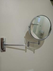 a mirror attached to a wall with a metal holder at Sweet Escape 22 at O Residences in Bacolod +27 photos