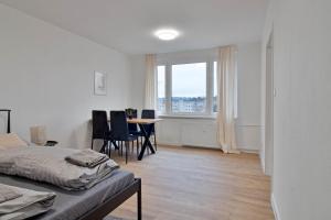 a bedroom with a bed and a table and chairs at Moskovska with Public Parking in Banská Bystrica