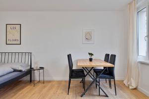 a room with a table and chairs and a bed at Moskovska with Public Parking in Banská Bystrica