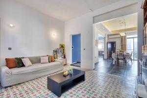 a living room with a couch and a table at Stunning 3BR breathtaking views outdoor dining in Rabat
