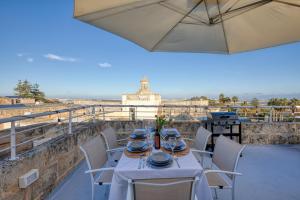 a table and chairs on a balcony with a view at Stunning 3BR breathtaking views outdoor dining in Rabat