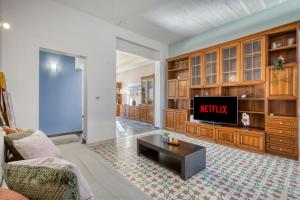 a living room with a couch and a tv at Stunning 3BR breathtaking views outdoor dining in Rabat