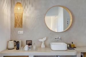 a bathroom with a sink and a mirror at Thalassa Naxos in Kastraki