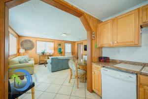 a kitchen and living room with a couch and a table at Cg Beach Bungalow #1 in Myrtle Beach