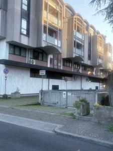 a large building on a street next to a road at Residence Concordia in Gorizia
