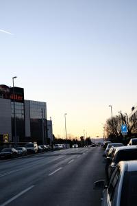 an empty street with parked cars in a parking lot at The White House Split in Split