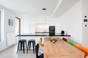a kitchen with a wooden table and chairs at Perfectly situated condo with amazing views in Ostend
