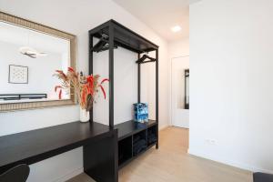 a dressing room with a black vanity and a mirror at Perfectly situated condo with amazing views in Ostend +23 photos