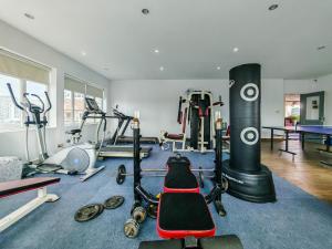 a gym with several treadmills and machines in a room at La Belle Residence in Phnom Penh