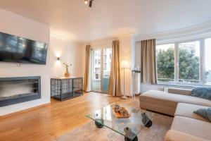 a living room with a couch and a table at Appartement Montfleuri in Ostend