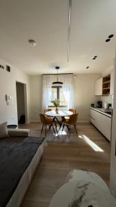 a large living room with a table and a kitchen at By The River Stay in Florina