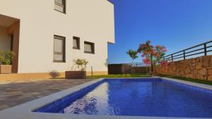 a swimming pool in front of a house at Holiday house VILLA PATRICK with pool, jacuzzi and sauna in Kornić