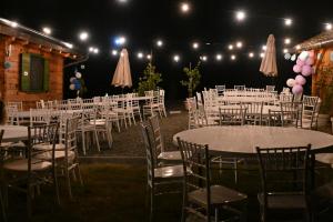 a group of tables and chairs with pink and purple balloons at Kozara Panoramic Resort in Bosanska Gradiška +129 photos