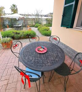 a black table and chairs with a plate on it at The Shell in Vallecrosia