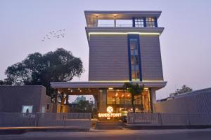 a building with a clock tower on top of it at Sands Point Hotel in Pondicherry