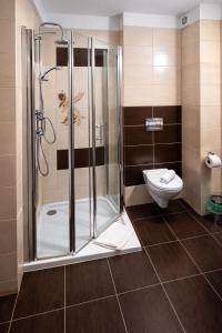 a bathroom with a shower and a toilet at Hotel Olimpik Park in Słubice +31 photos