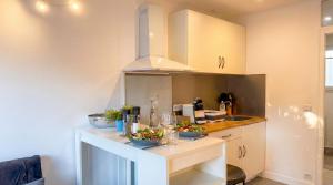 a kitchen with a counter with bowls of food on it at Cozy & elegant, proche de Martigues in Saint-Mitre-les-Remparts