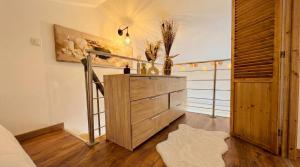 a bedroom with a wooden dresser and a balcony at Cozy & elegant, proche de Martigues in Saint-Mitre-les-Remparts