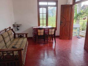 a living room with a couch and a table at Browns Hill Villa - Ella in Ella