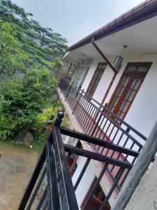 a balcony of a house with a fence at Browns Hill Villa - Ella in Ella +5 photos