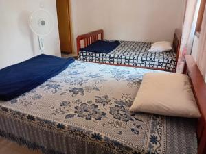 two beds in a small room with a fan at Browns Hill Villa - Ella in Ella