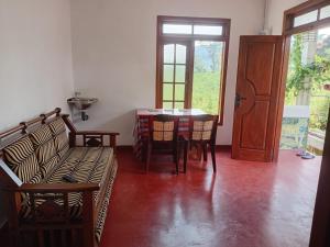a living room with a table and chairs and a door at Browns Hill Villa - Ella in Ella